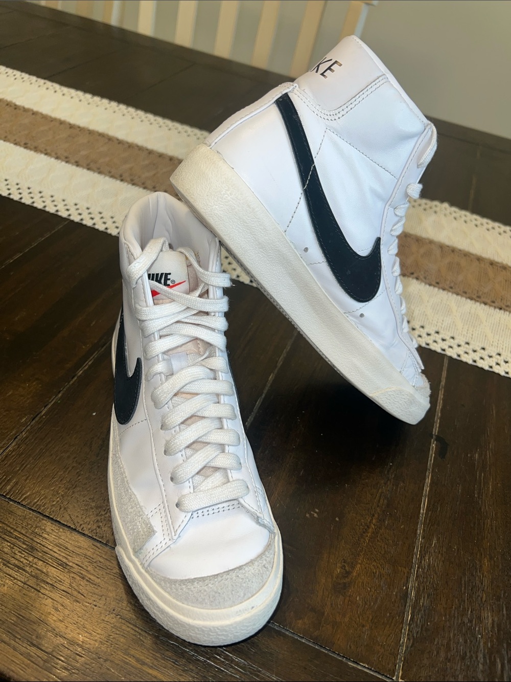 Nike women’s White High-Top Sneakers with Black Swoosh Accent